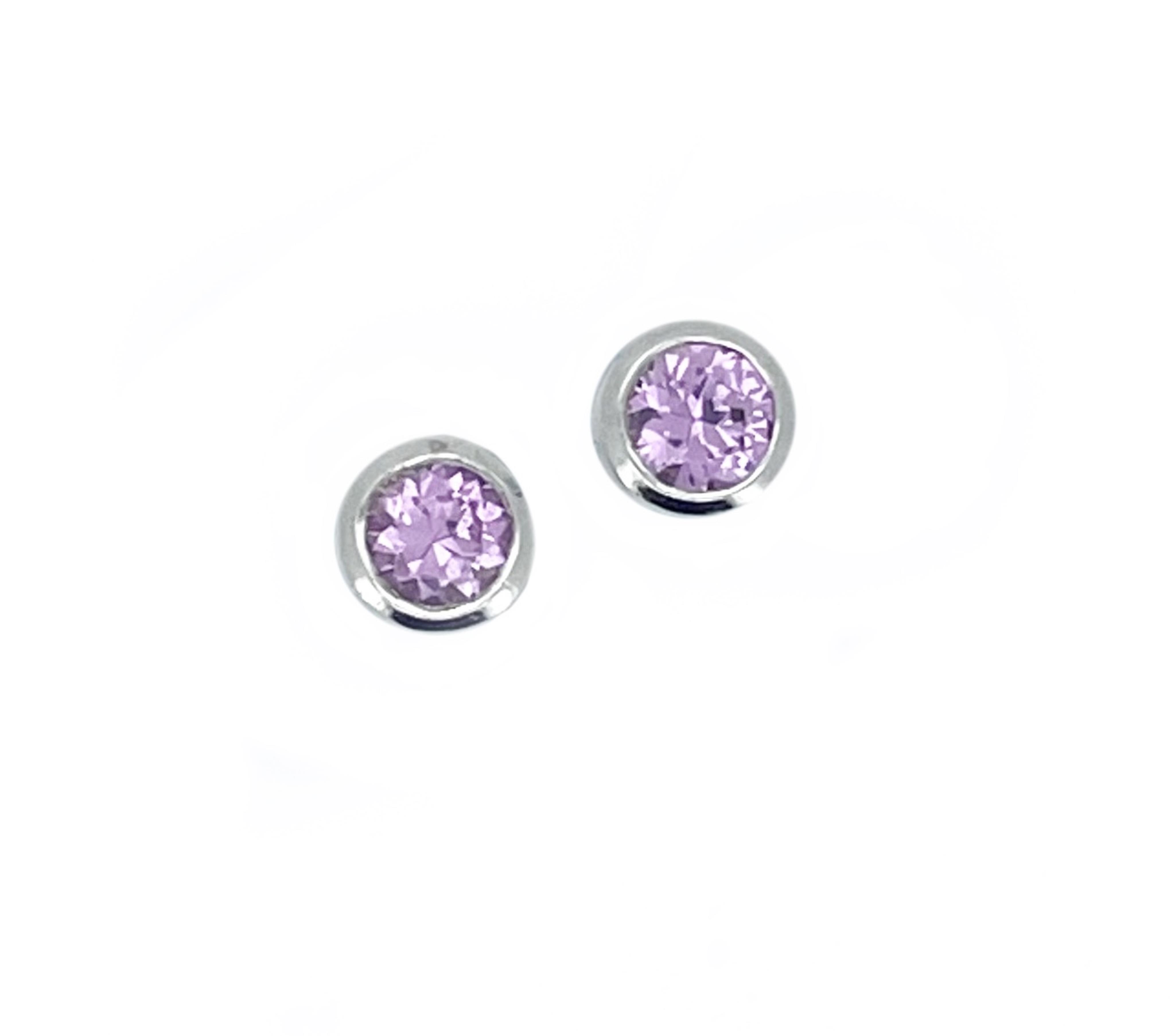 A pair of modern white metal, stamped 750 and single stone pink sapphire set ear studs, gross weight 1.5 grams.